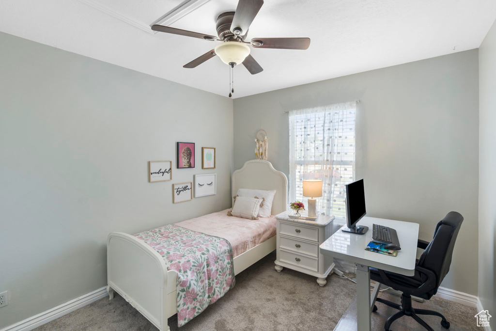 Carpeted bedroom featuring ceiling fan