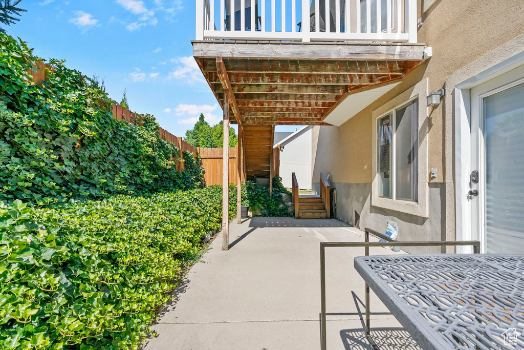 View of patio featuring a balcony