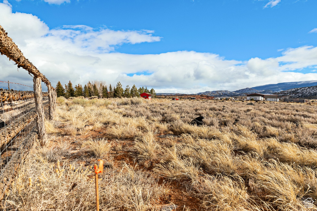 Property view of mountains with a rural view