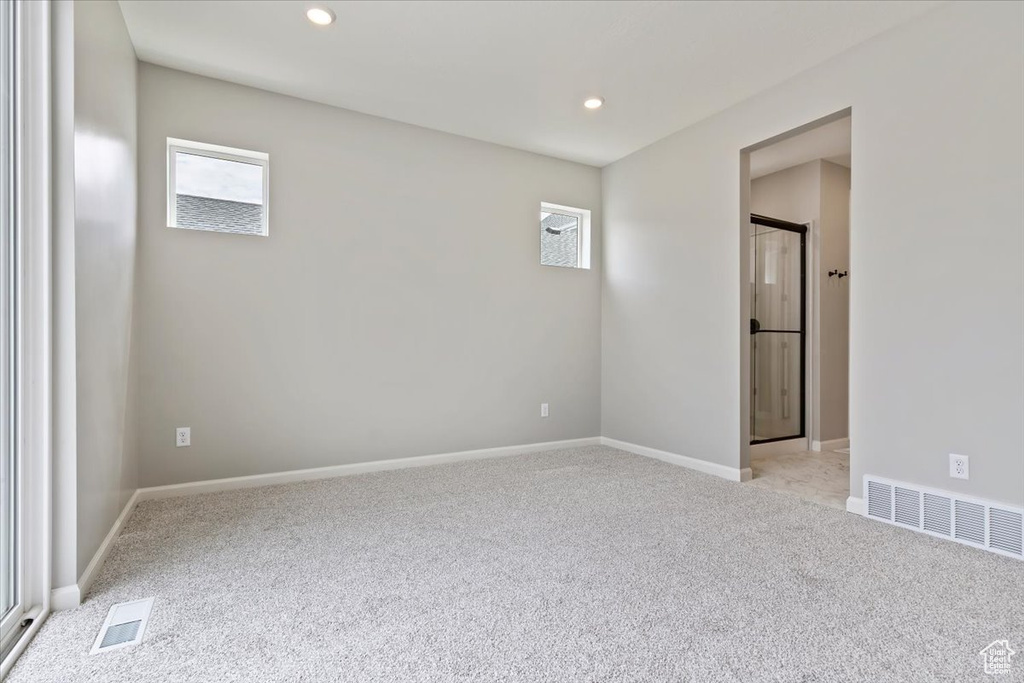 Empty room with light colored carpet