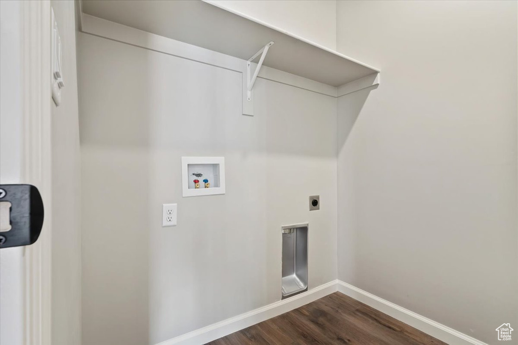 Clothes washing area with washer hookup, electric dryer hookup, and dark wood-type flooring