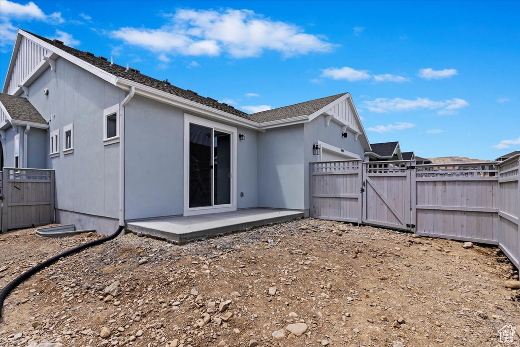 Back of property with a patio