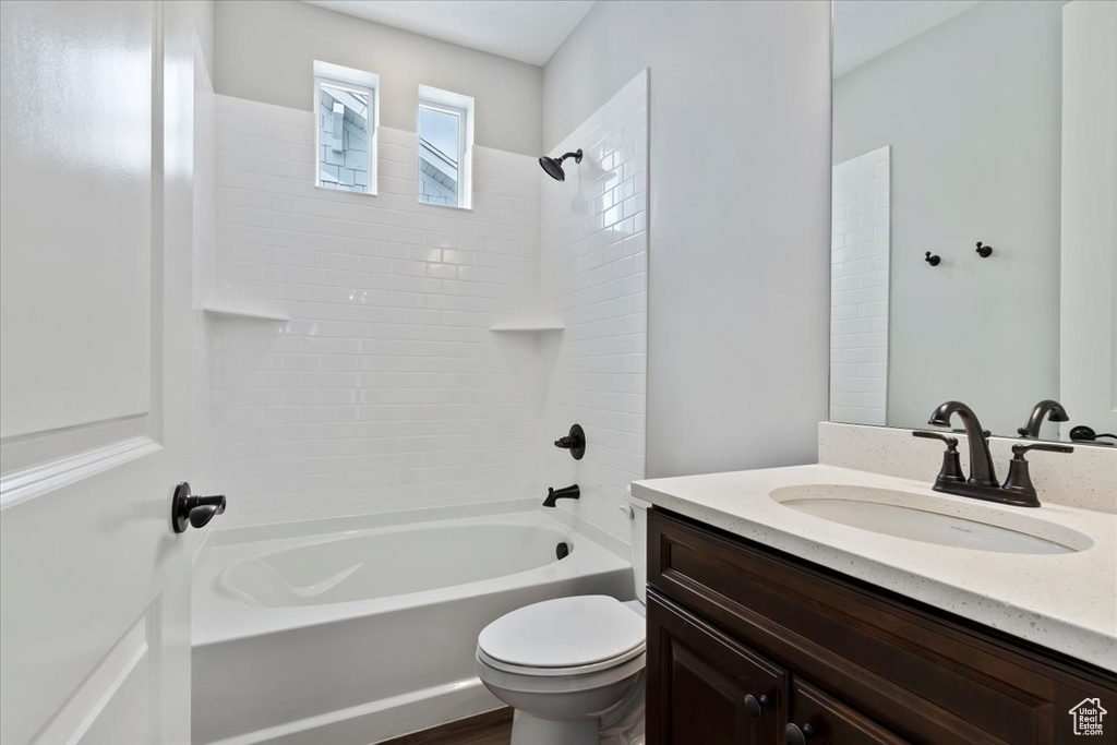 Full bathroom with vanity, shower / bath combination, and toilet