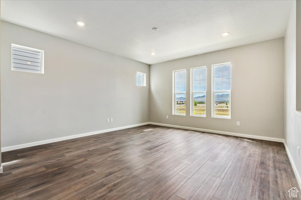 Empty room featuring hardwood / wood-style flooring