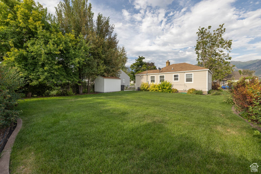 View of yard with a storage unit