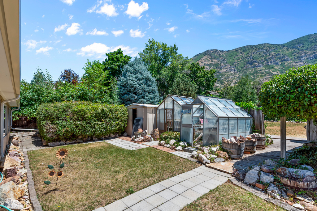 View of yard with a mountain view and an outbuilding