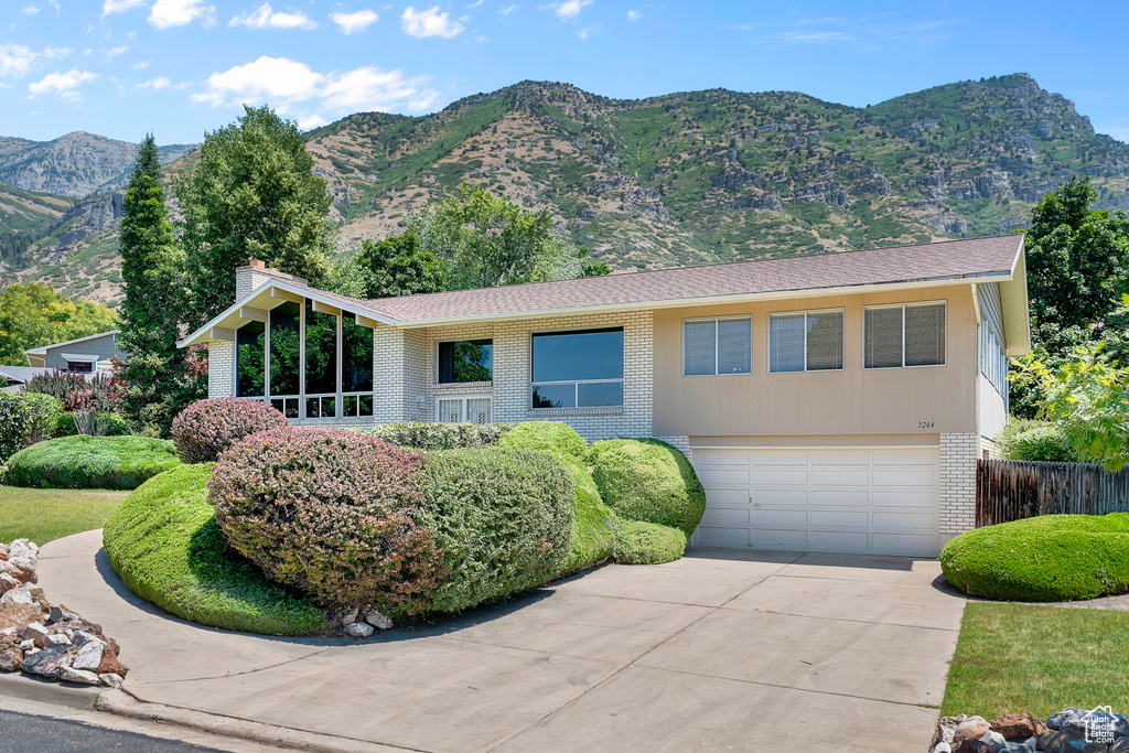 Ranch-style house featuring a garage and a mountain view