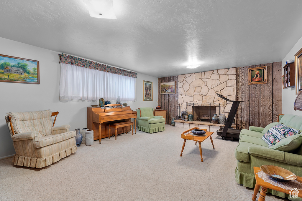 Living room with carpet and a stone fireplace