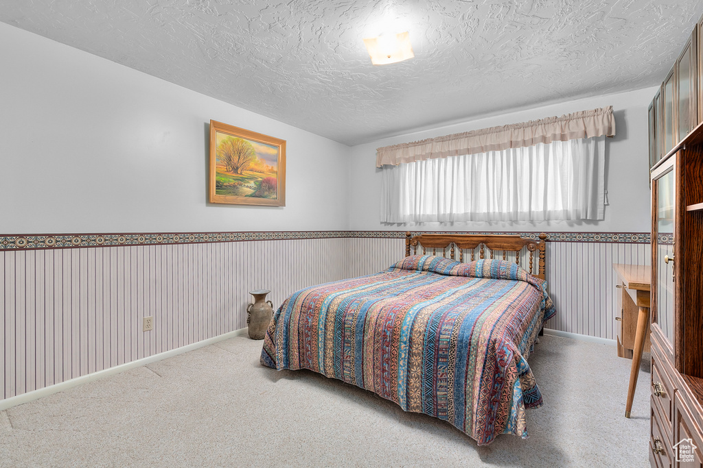 Bedroom with carpet floors and a textured ceiling