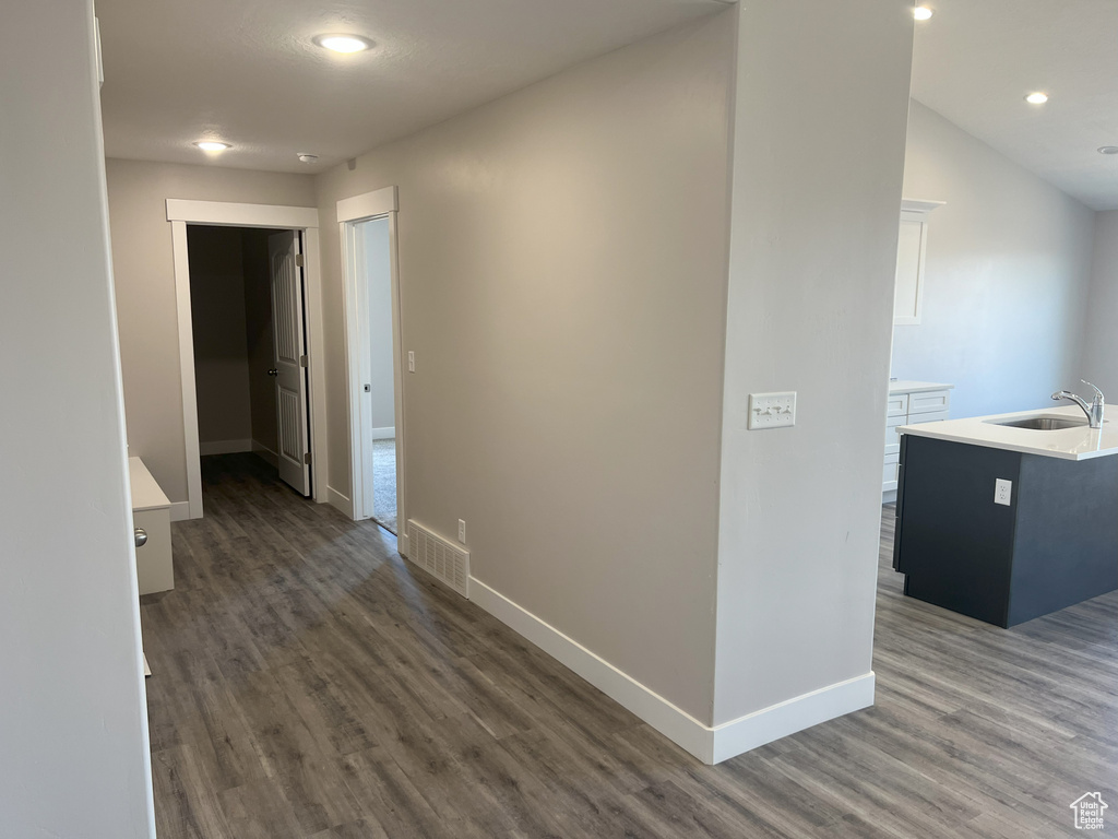 Hall with sink and hardwood / wood-style floors