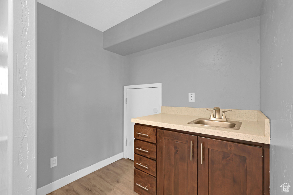 Bathroom featuring vanity and wood-type flooring