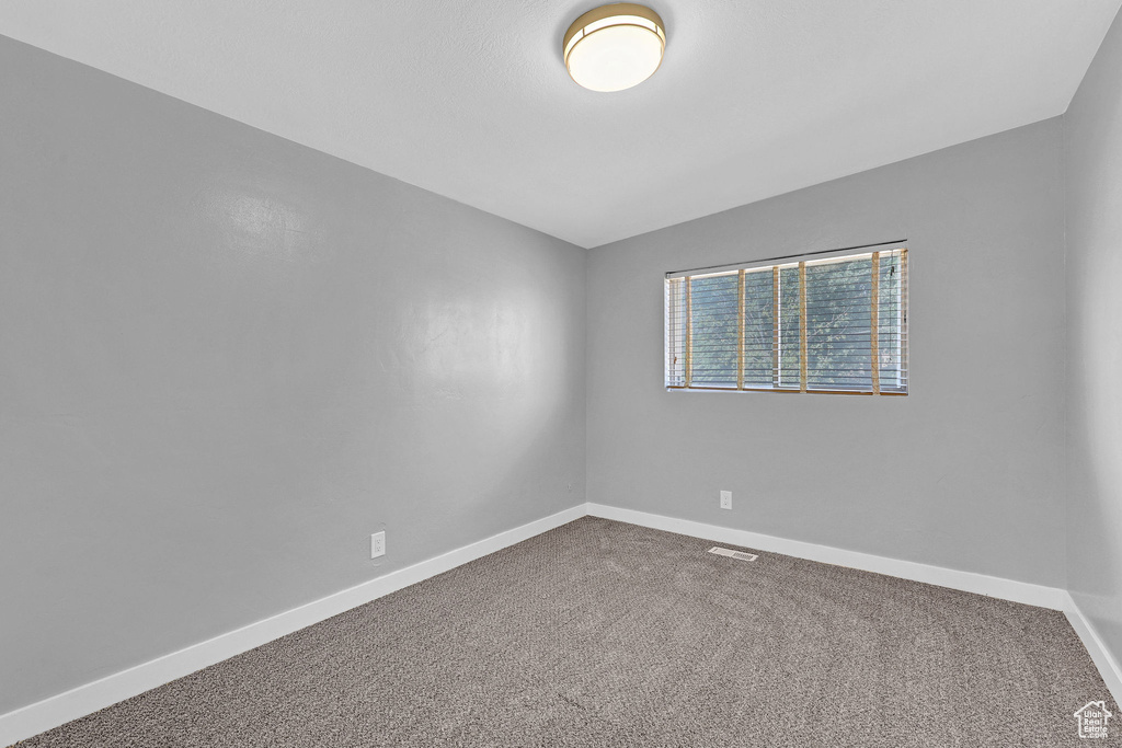 Empty room featuring carpet floors