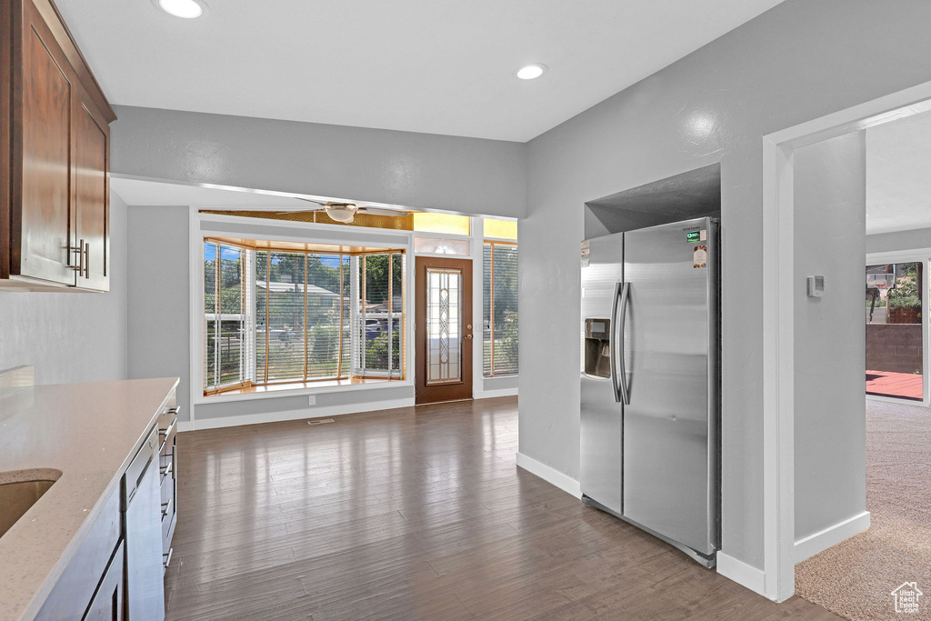 Kitchen with stainless steel refrigerator with ice dispenser and dark carpet