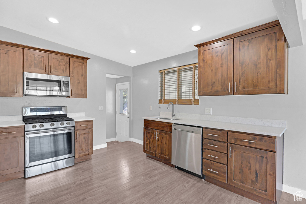 Kitchen featuring sink, appliances with stainless steel finishes, and light wood-type flooring