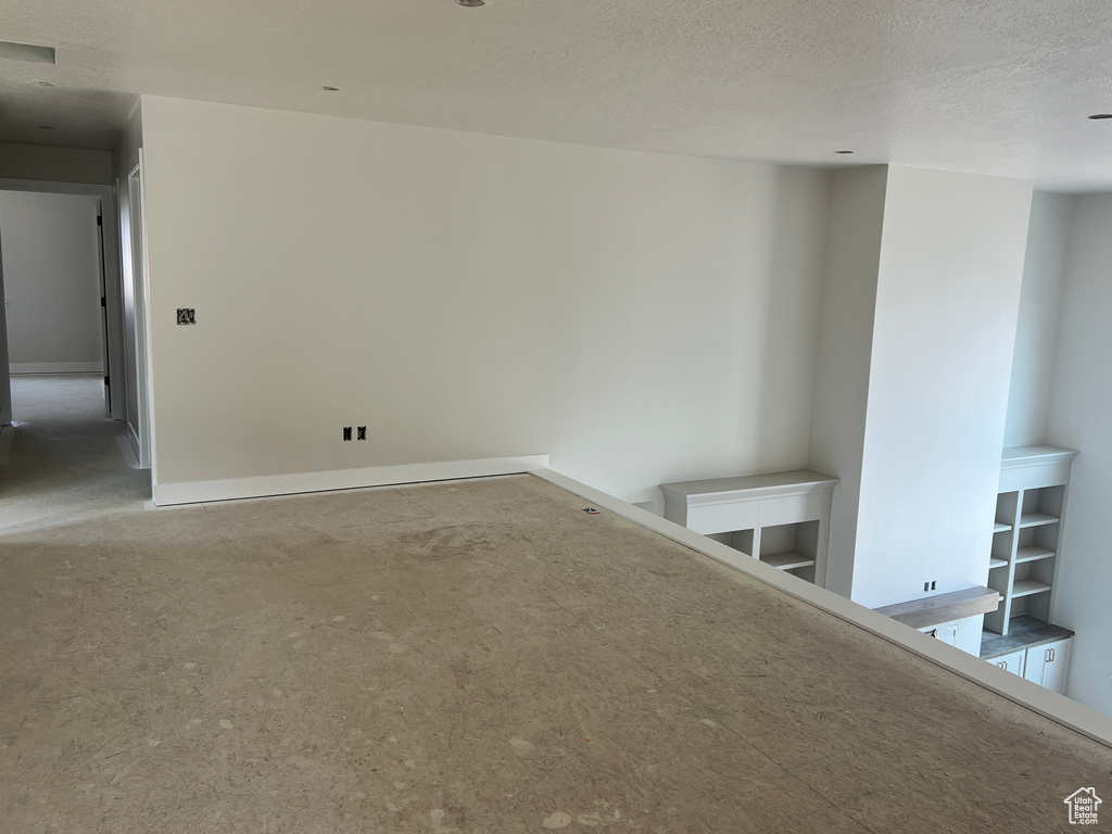 Unfurnished room featuring a textured ceiling