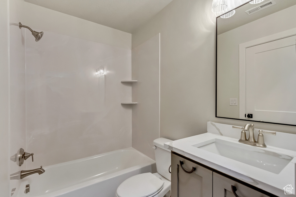 Full bathroom featuring vanity,  shower combination, and toilet