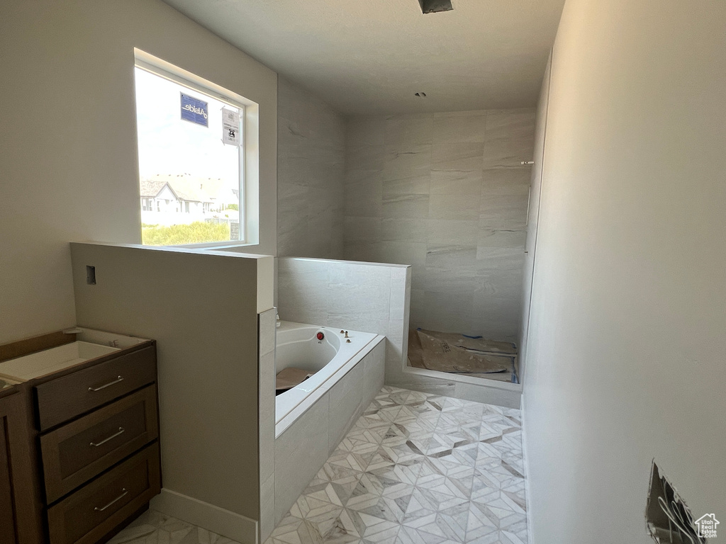 Bathroom with shower with separate bathtub and vanity