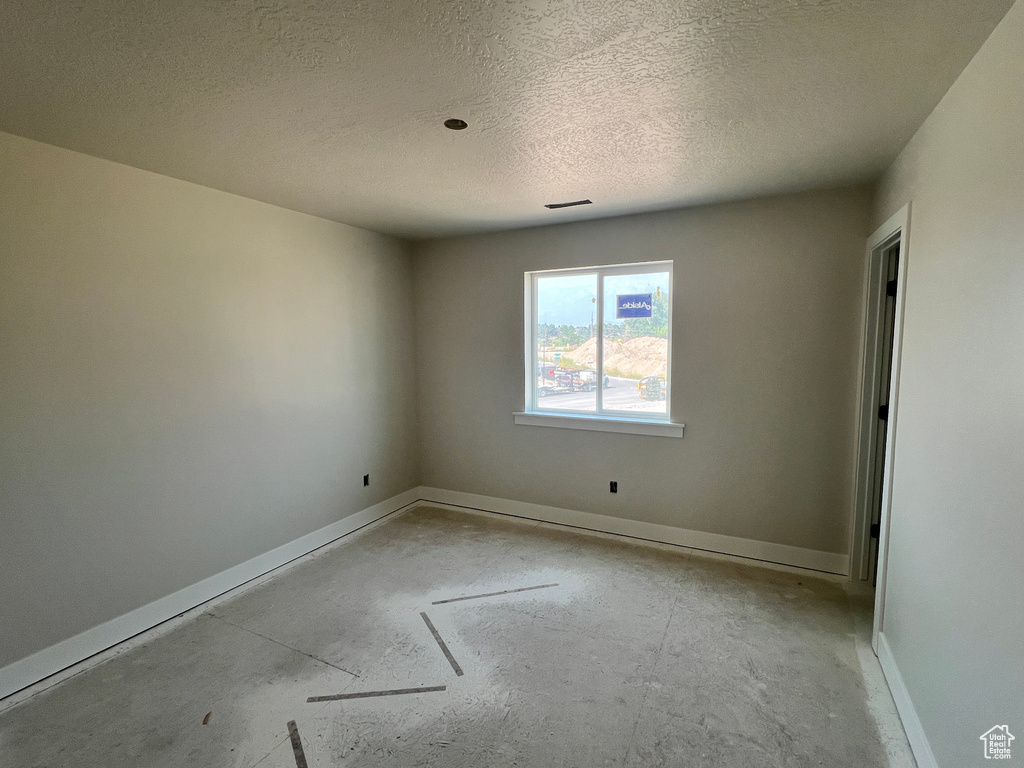 Empty room with a textured ceiling