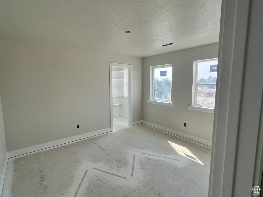 Empty room with a textured ceiling