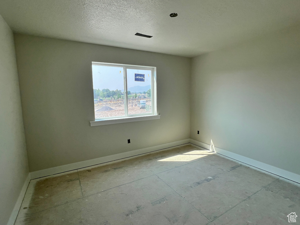 Spare room with a textured ceiling