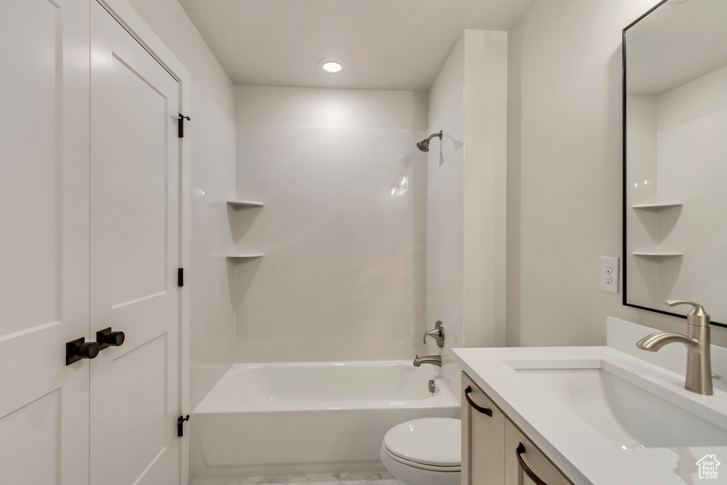 Full bathroom featuring washtub / shower combination, vanity, and toilet