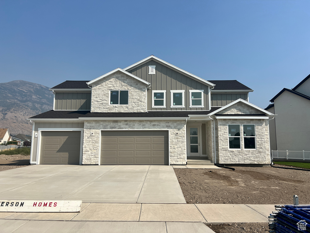 View of front facade with a mountain view and a garage