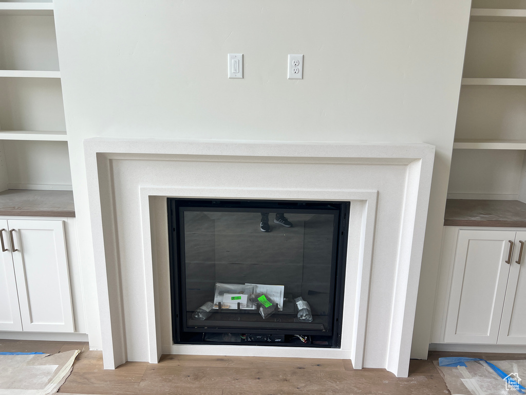 Interior details featuring built in features and hardwood / wood-style floors