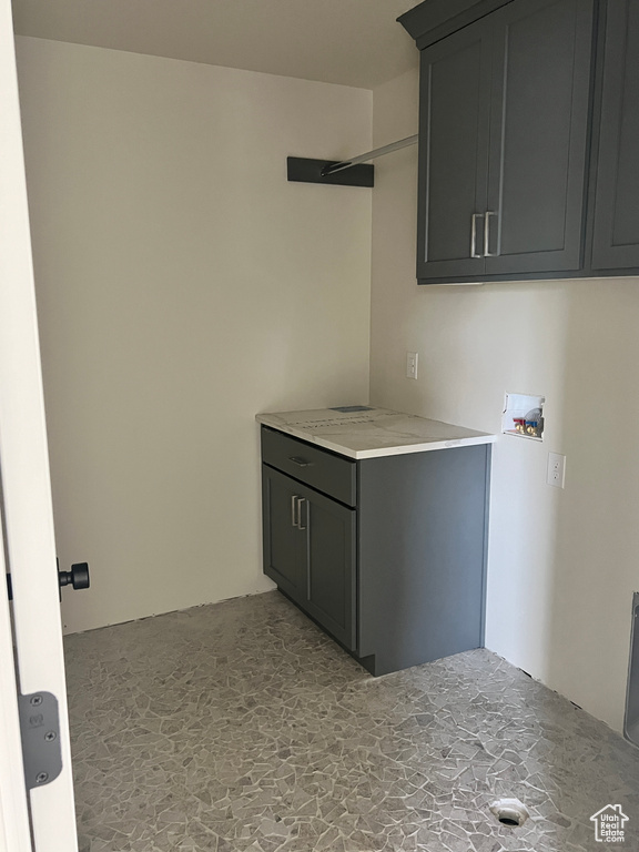 Laundry room with hookup for a washing machine and cabinets