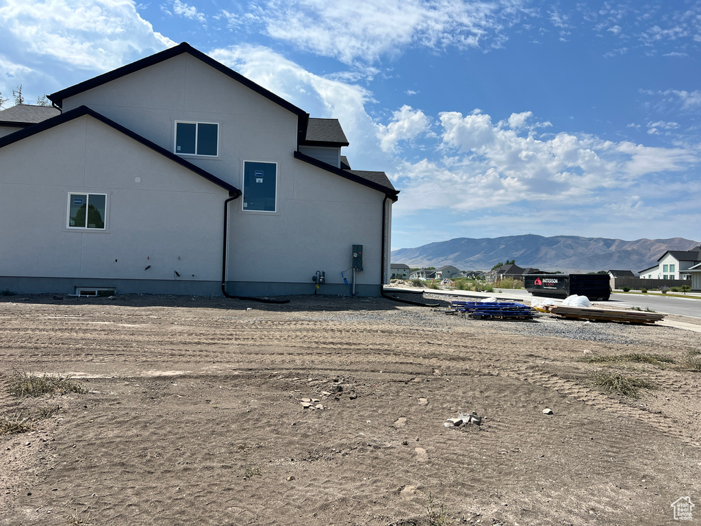 View of side of home featuring a mountain view