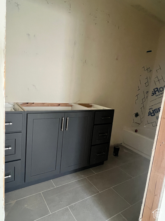 Bathroom with shower / tub combo with curtain, vanity, and tile patterned floors