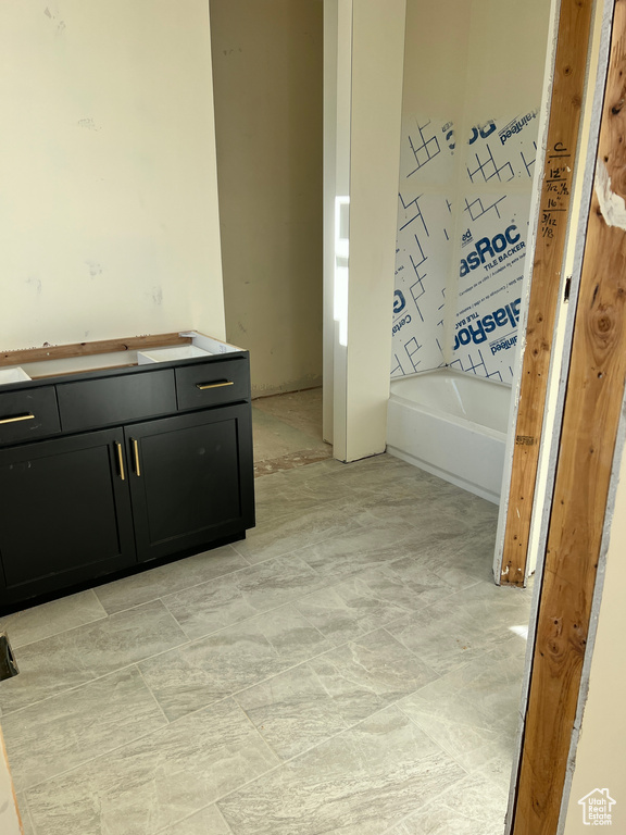 Bathroom with a tub to relax in and vanity