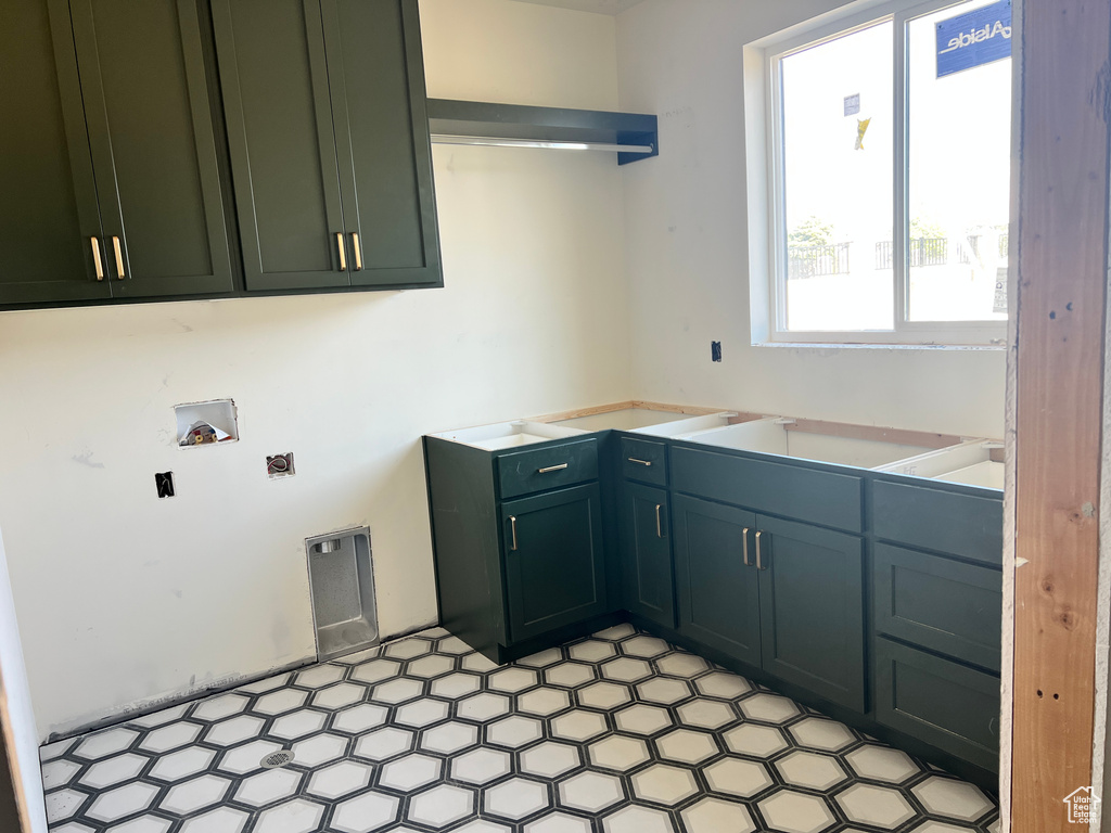 Washroom with cabinets and washer hookup