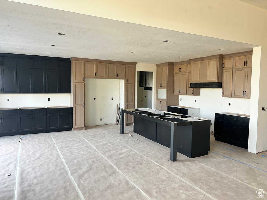 Kitchen featuring premium range hood and a kitchen island