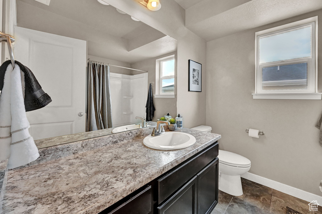 Bathroom with tile patterned floors, vanity, and toilet