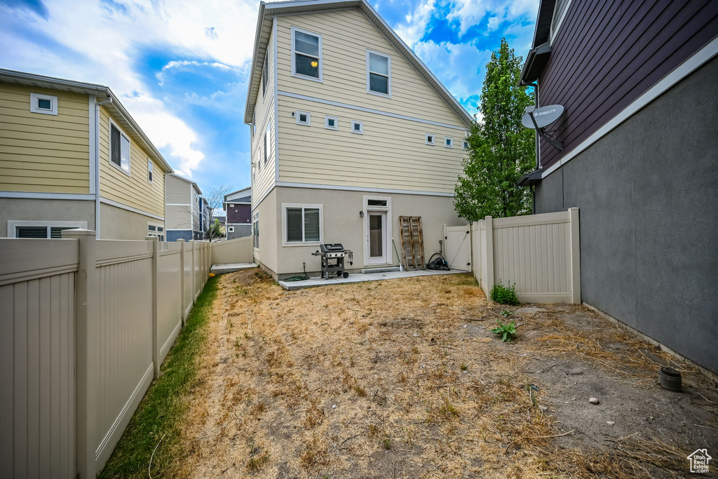 Rear view of property with a patio area