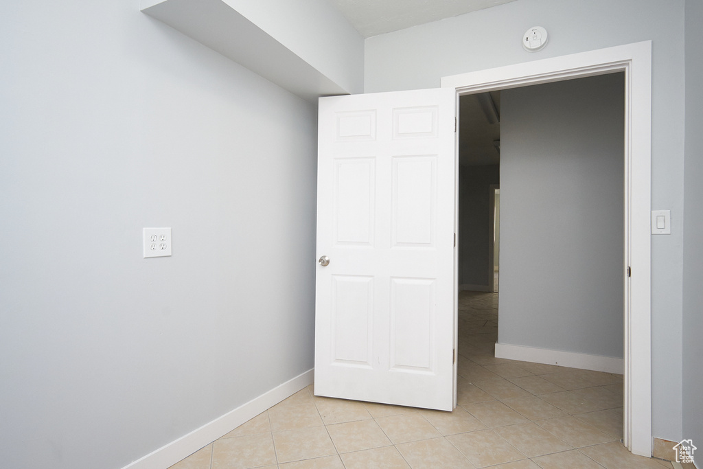 Spare room with light tile patterned flooring