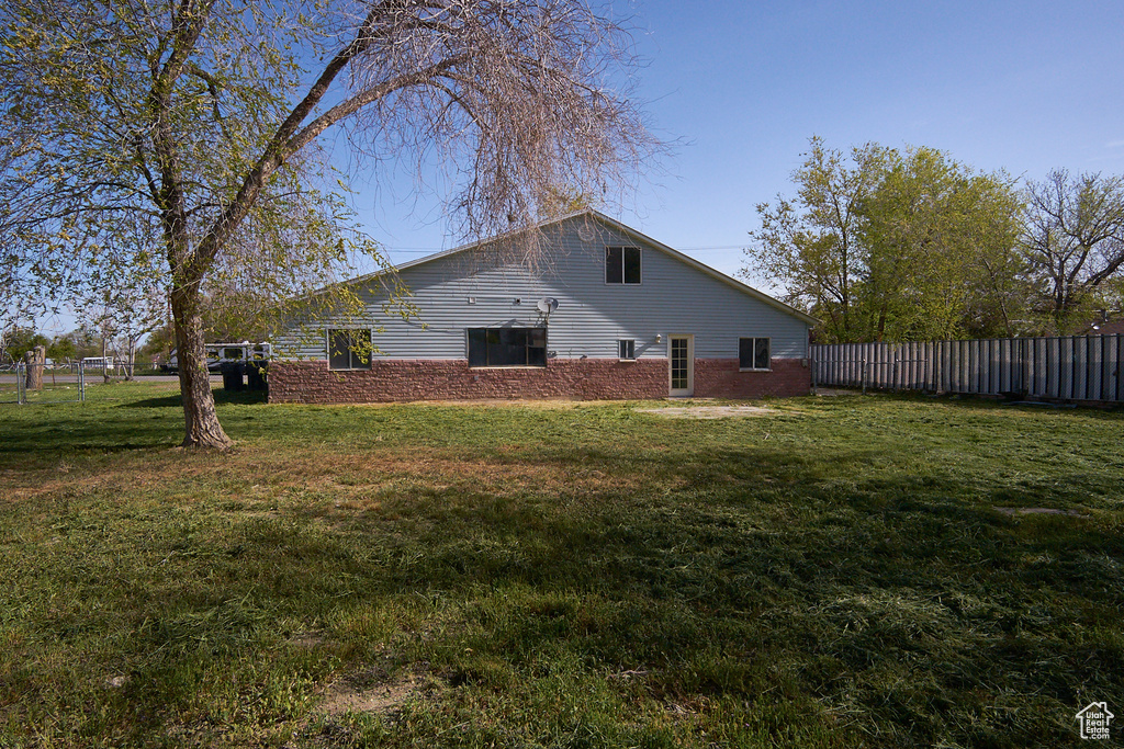 View of side of home with a yard