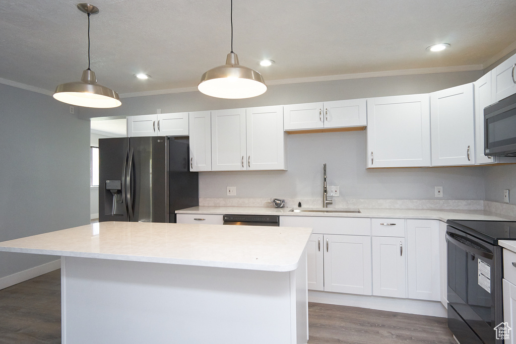 Kitchen featuring black appliances, sink, white cabinetry, dark hardwood / wood-style flooring, and ornamental molding