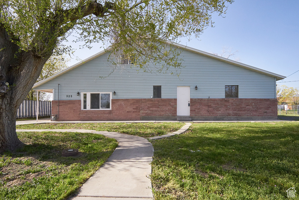 View of property exterior featuring a yard