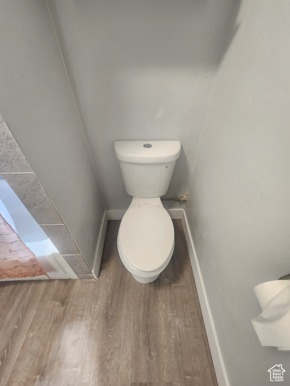 Bathroom with wood-type flooring and toilet