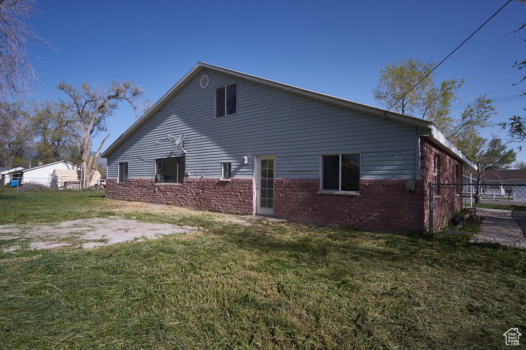 View of property exterior featuring a lawn