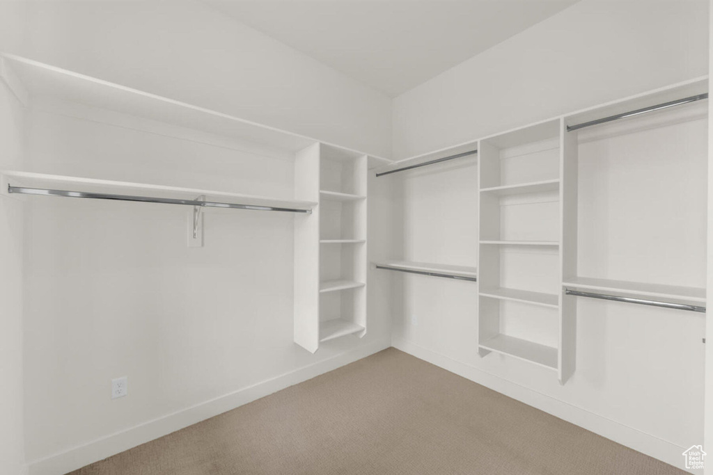 Spacious closet with light colored carpet