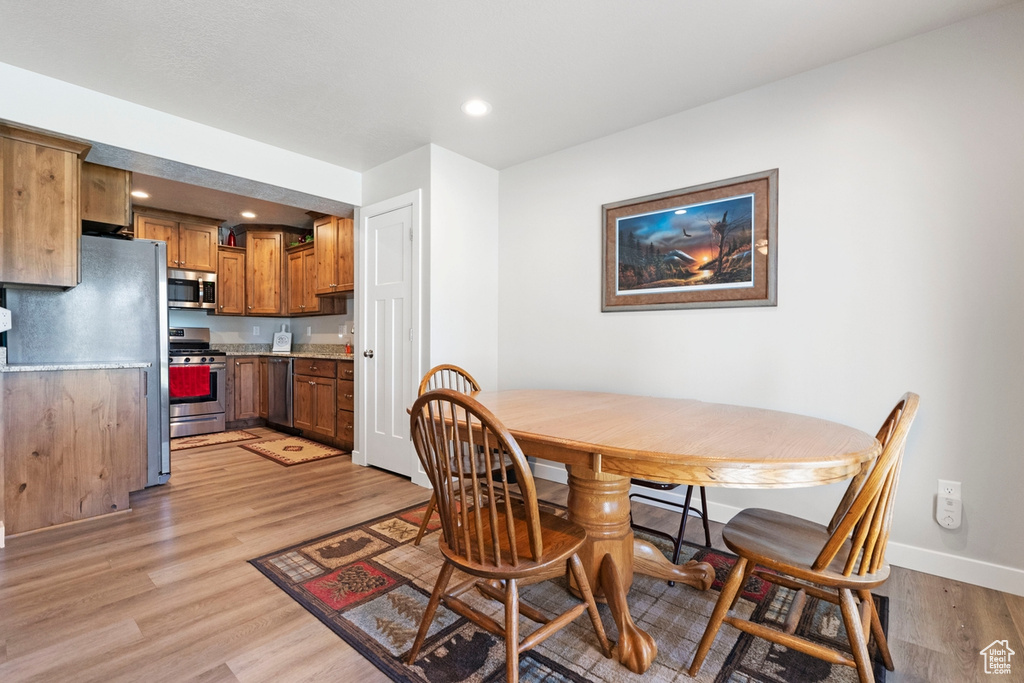 Dining room with light hardwood / wood-style floors