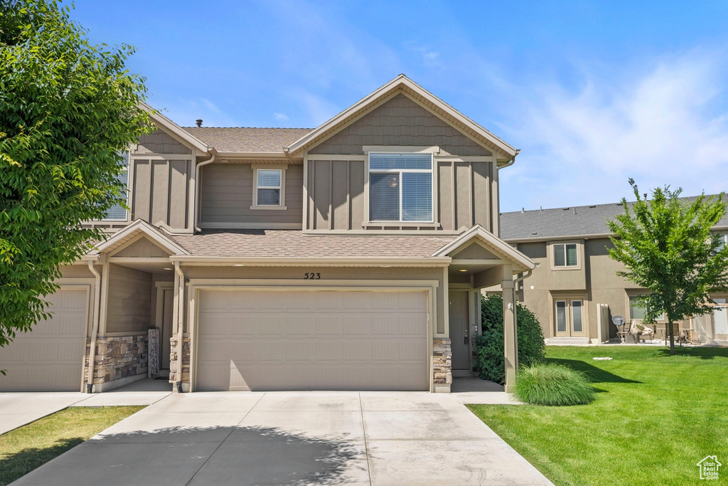 View of front of home featuring a garage and a front lawn