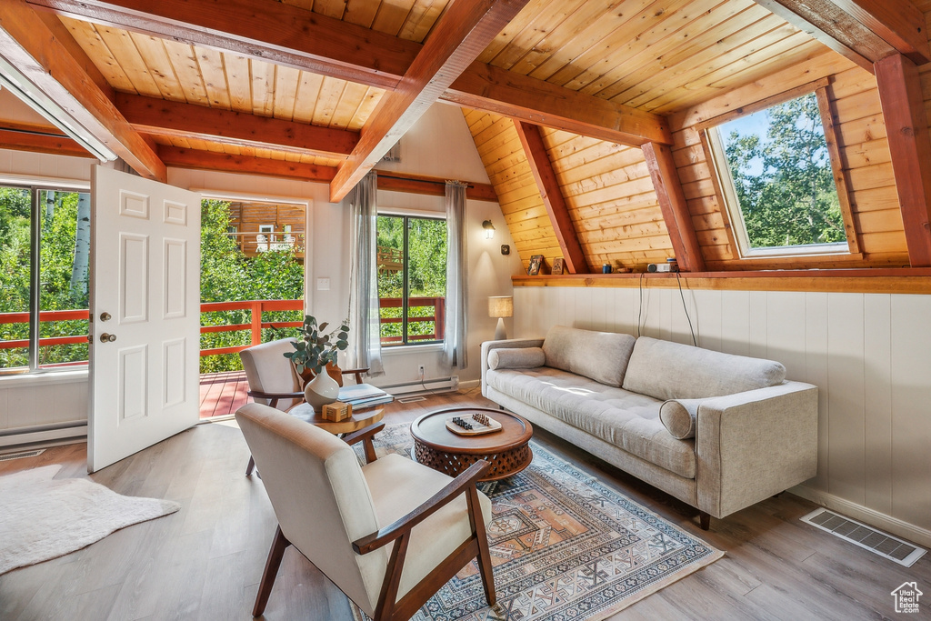 Living room featuring light hardwood / wood-style flooring, baseboard heating, wooden ceiling, and vaulted ceiling with beams