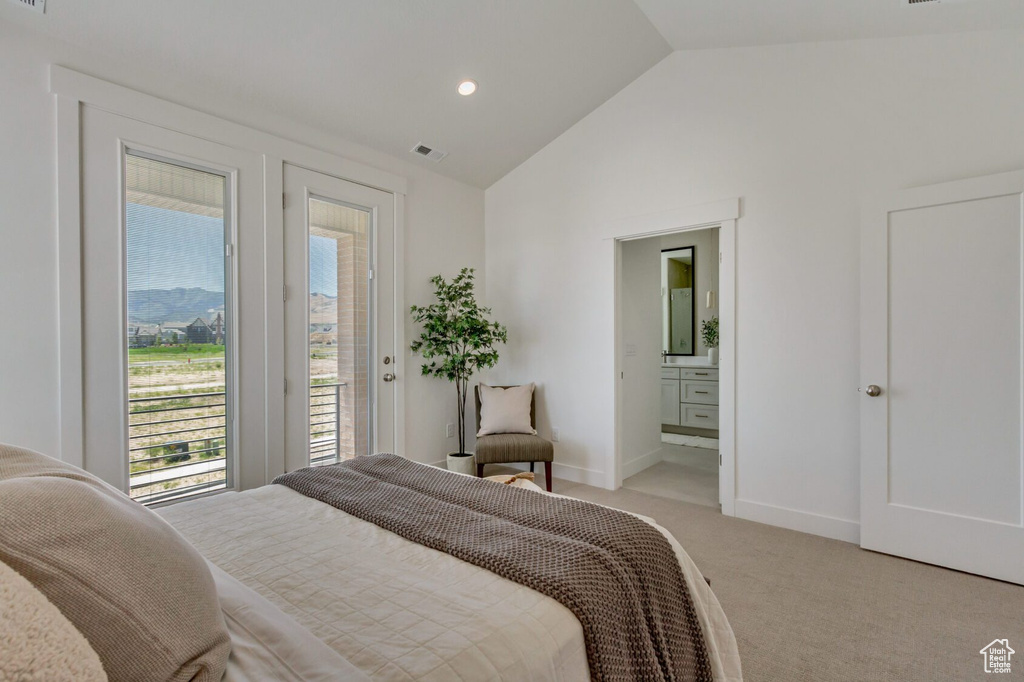 Bedroom featuring lofted ceiling, access to outside, ensuite bathroom, and carpet floors