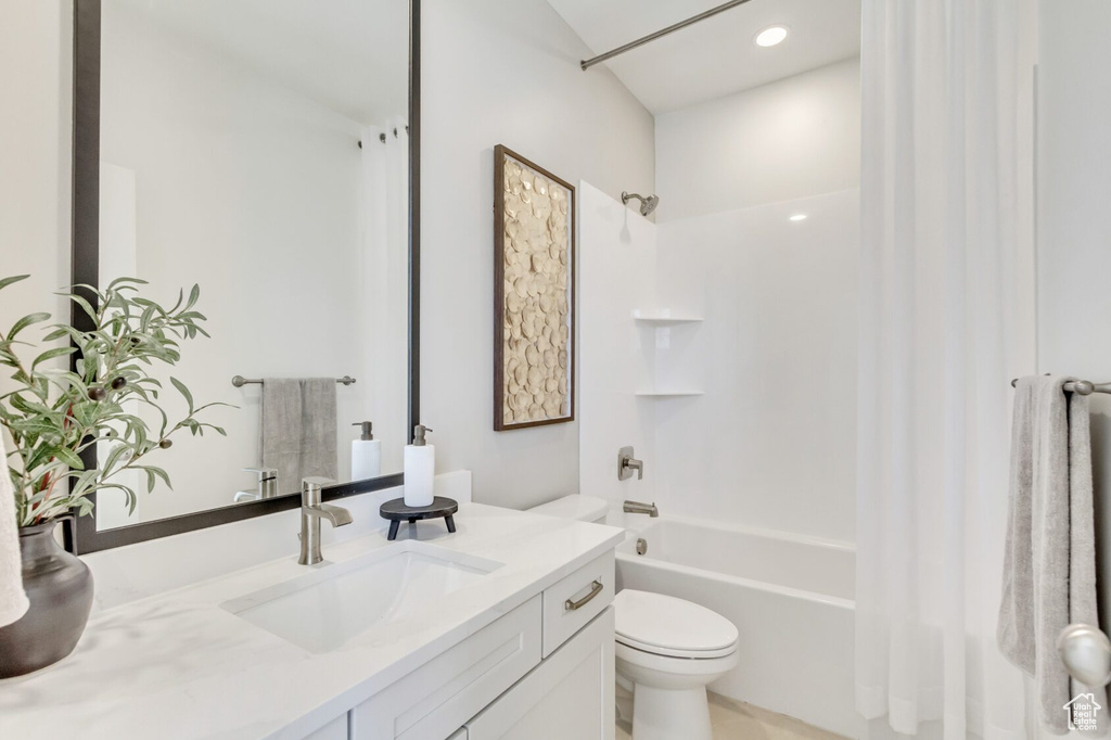 Full bathroom with vanity, toilet,  shower combination, and tile patterned flooring