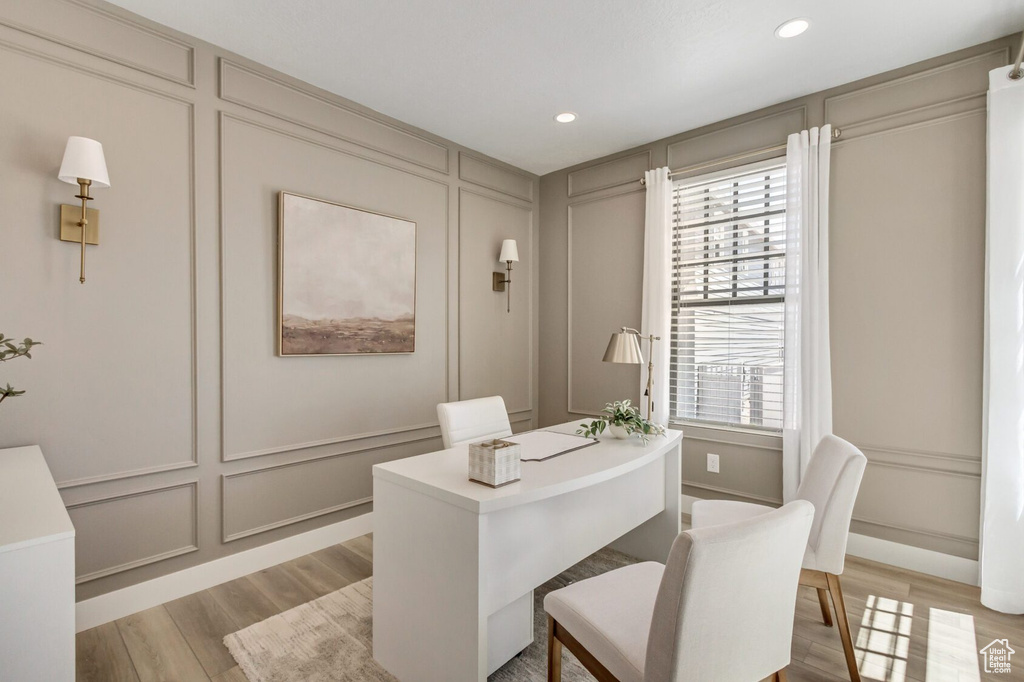 Office with hardwood / wood-style flooring and a wealth of natural light