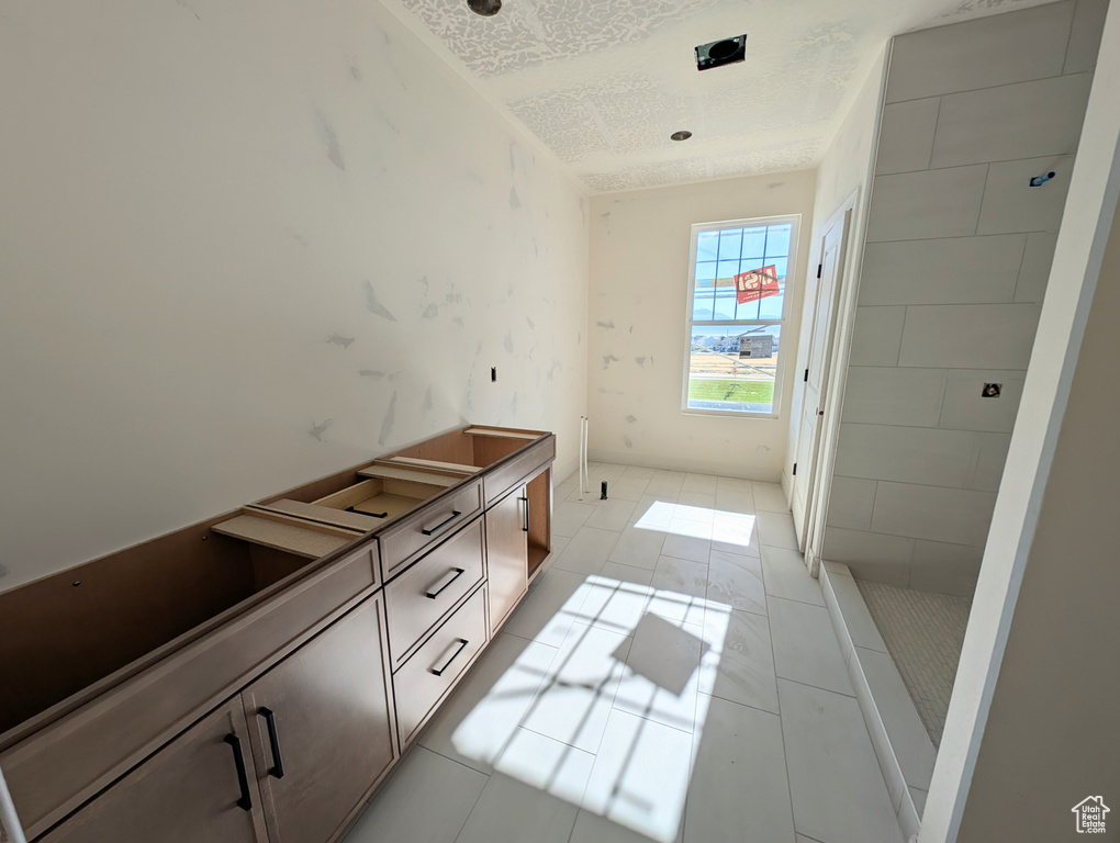 Bathroom with a textured ceiling and tile patterned floors