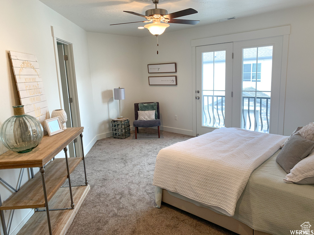 Carpeted bedroom featuring french doors, access to outside, and ceiling fan